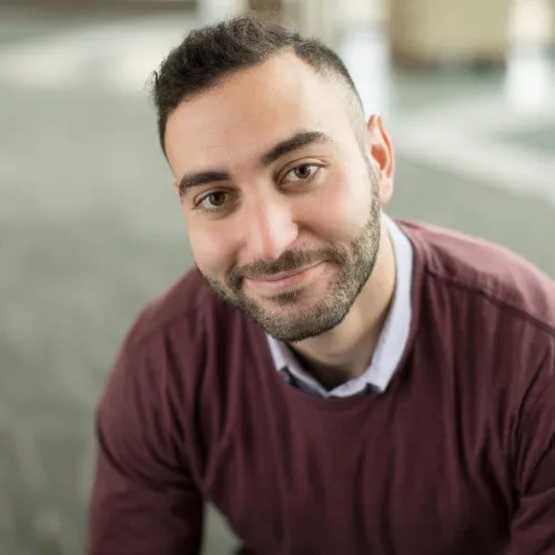 Tamir Haddad, a man with dark hair wearing a burgundy sweater.