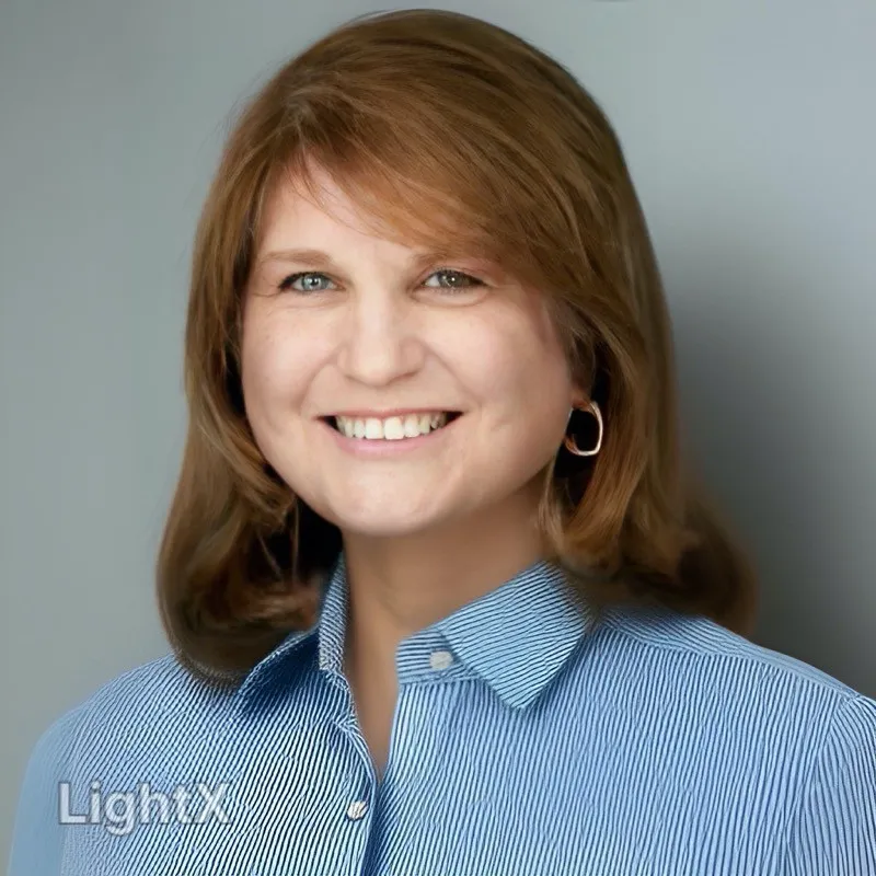 Kay Rindel, woman with chestnut hair and a blue collared shirt.