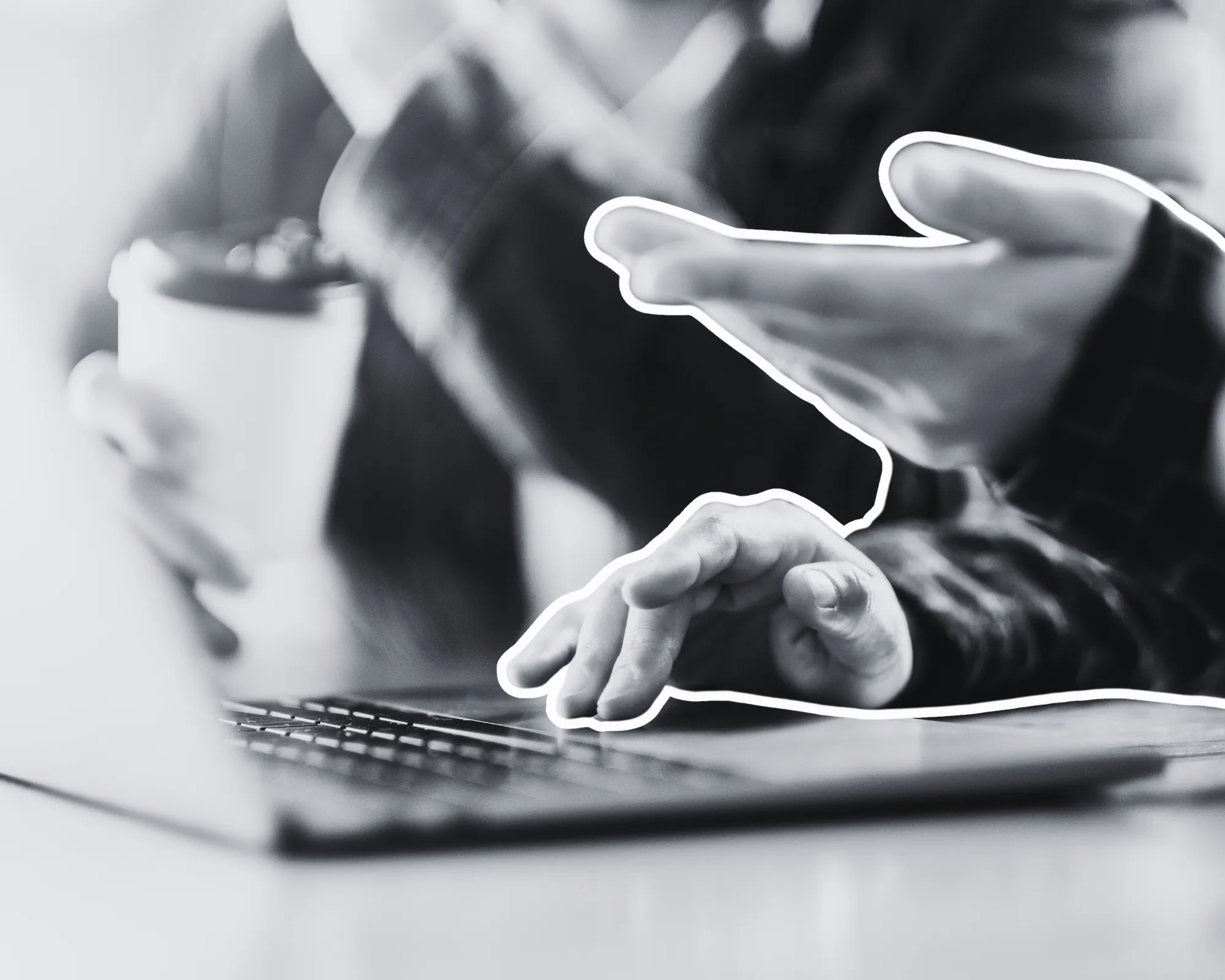 The hands of two professionals having a discussion at a laptop.