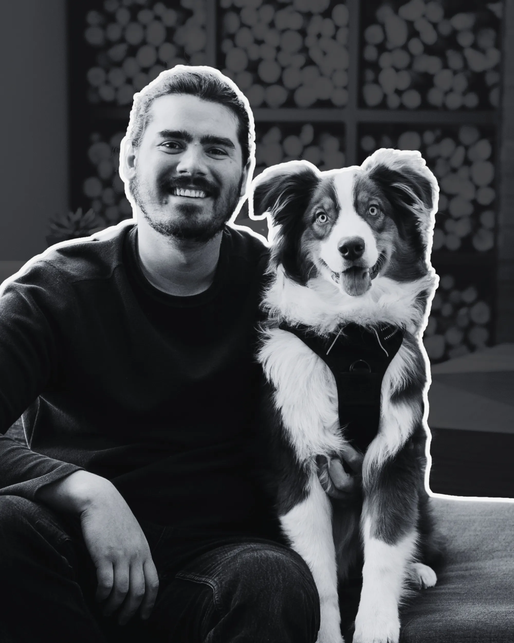 A photo of Taylor Scher, a professional man in his twenties with dark hair and a happyAustralian shepherd.