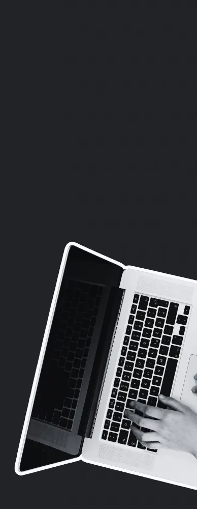 A laptop with hands typing.