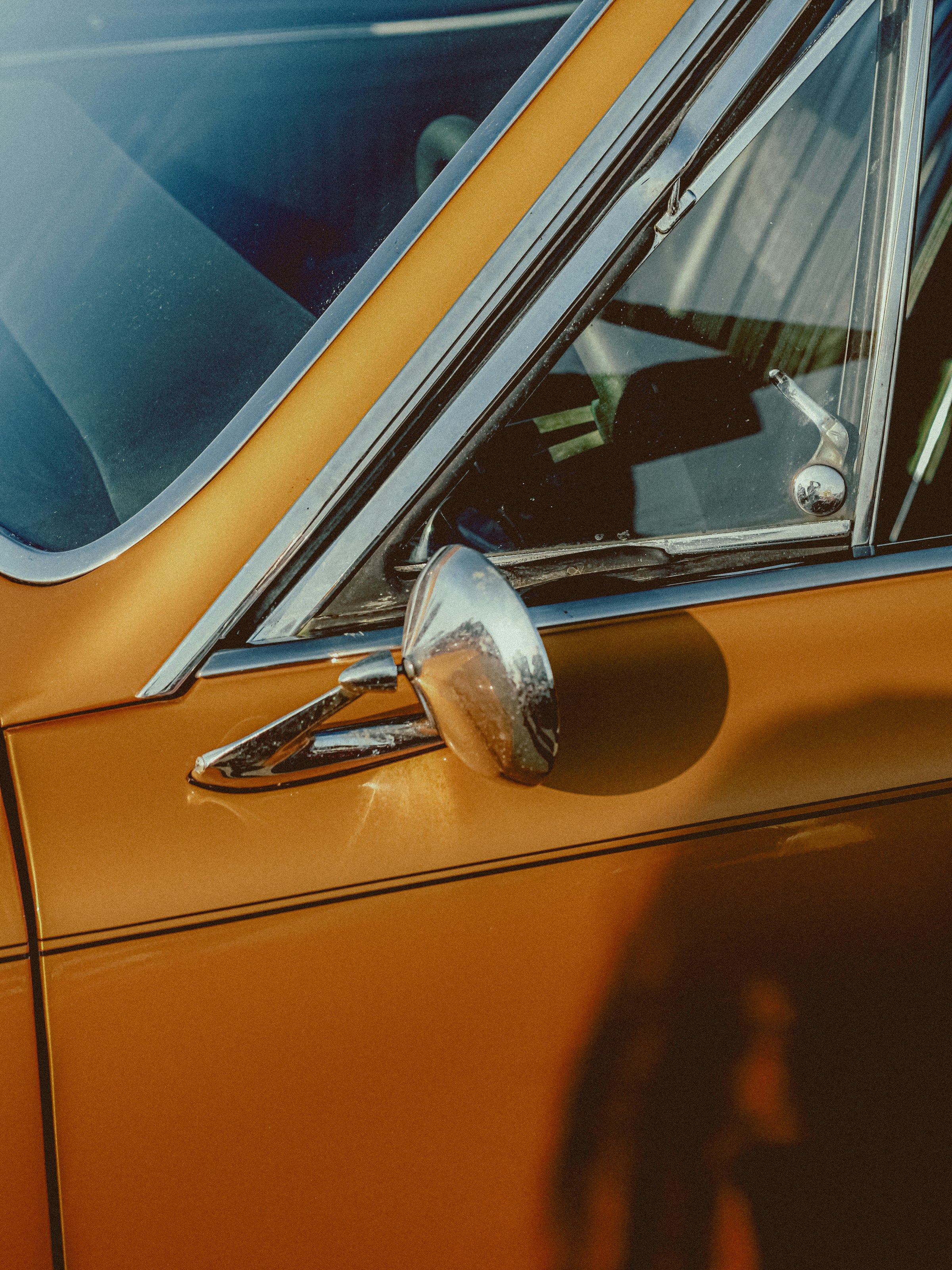 an orange car with the sin shining through it.