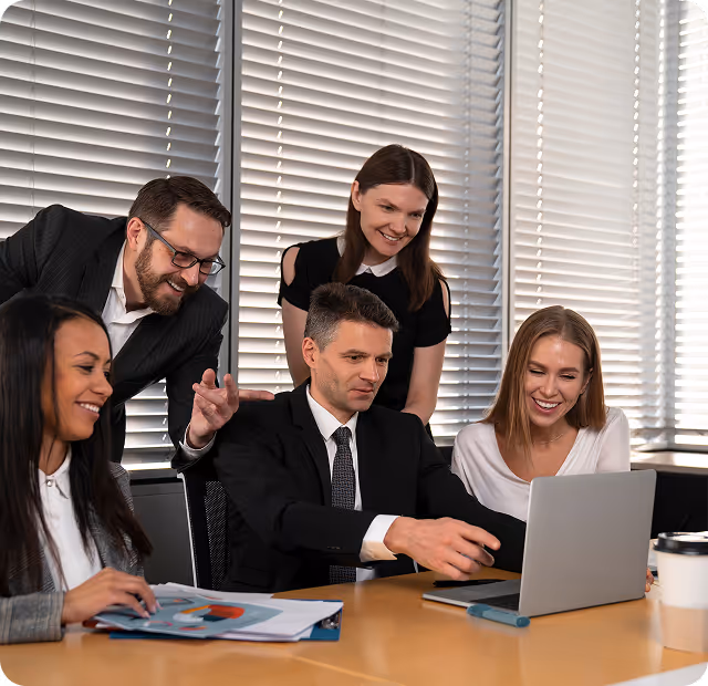 revLogic team collaborating in bright office with laptop and documents