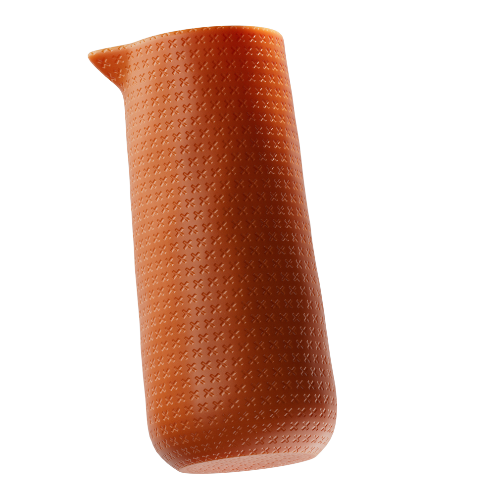 Orange ceramic pitcher with raised cross pattern on surface.