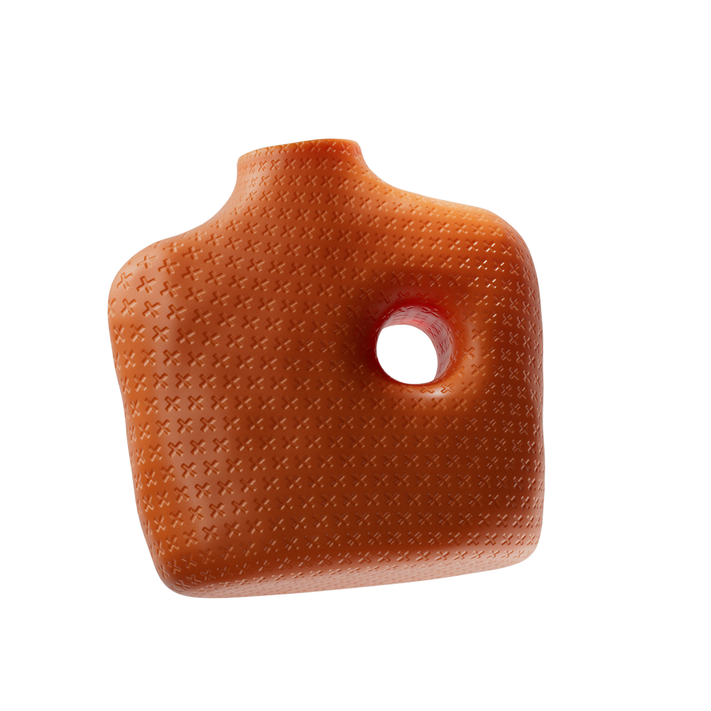Orange ceramic vase with a textured cross pattern and a large circular hole on one side.