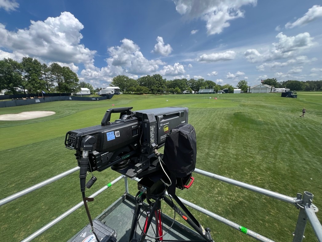 A camera on a stand on a golf courseDescription automatically generated, Picture