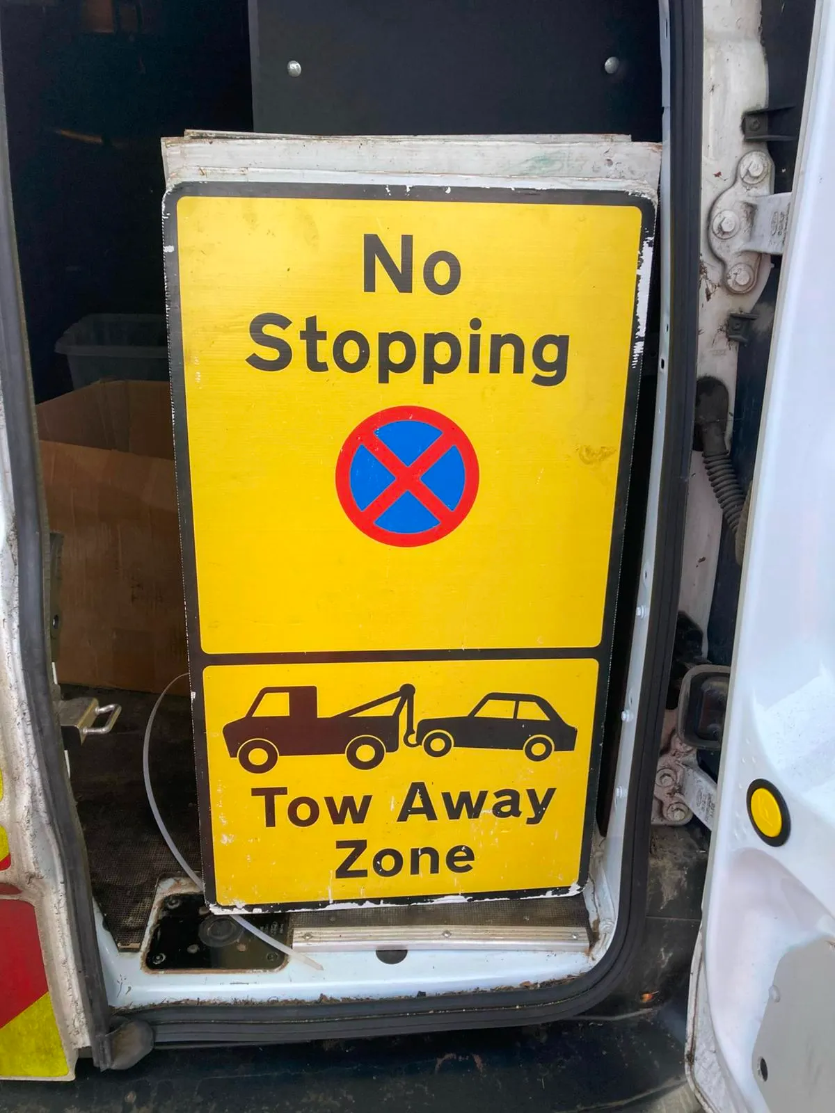 road sign showing no stopping and tow away zone