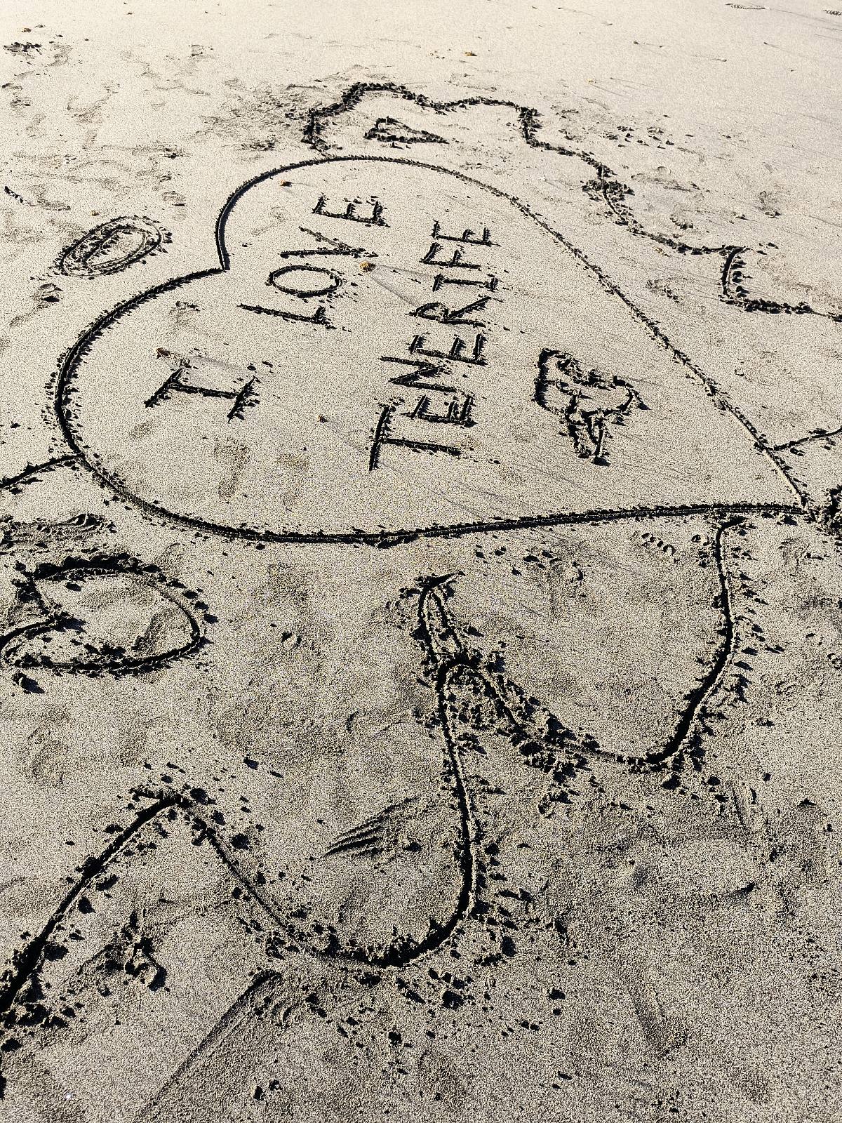 written words "I LOVE TENERIFE" on the sandy beach