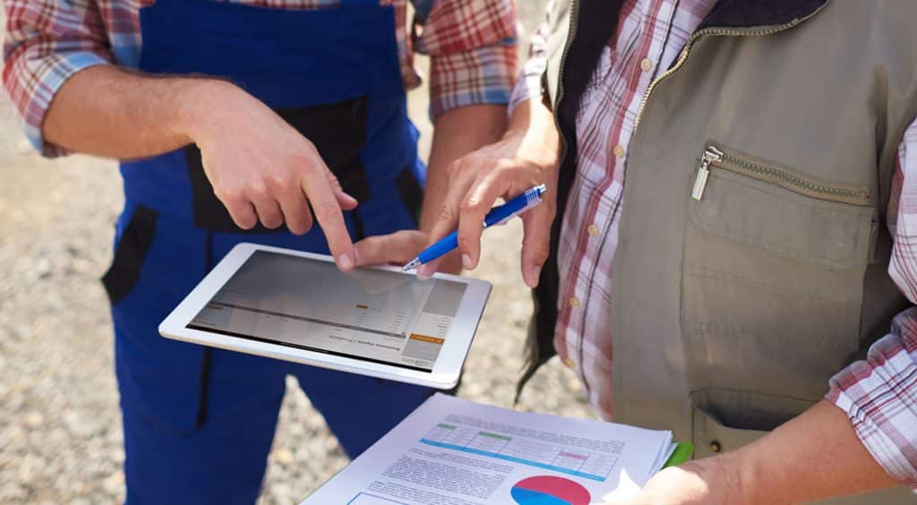 Tablet and smartphone displaying the Simple Farms margin analysis app interface used for tracking farm costs and profitability.