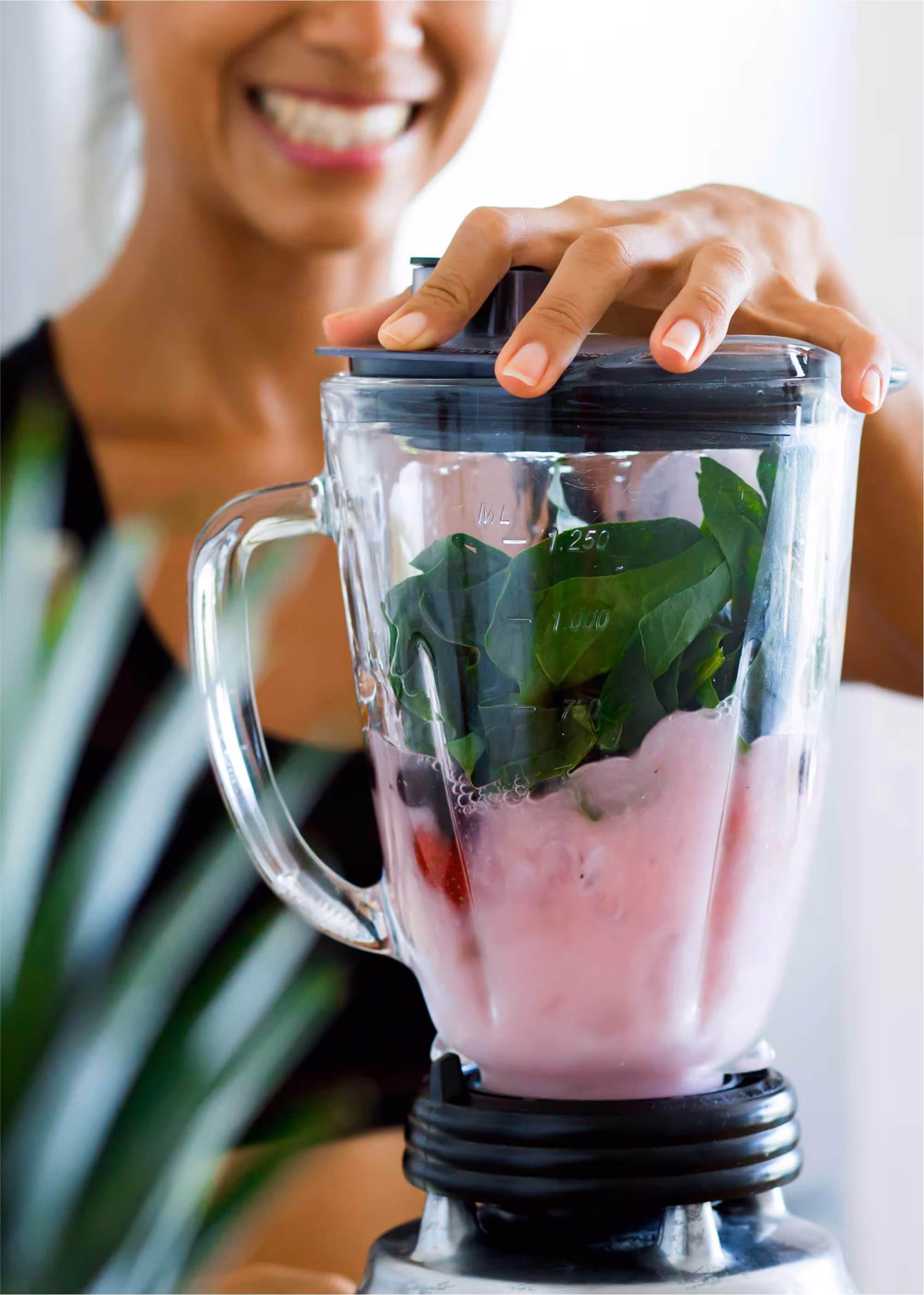 Woman making a healthy smoothie, changing her personal conditions to fuel high performance.