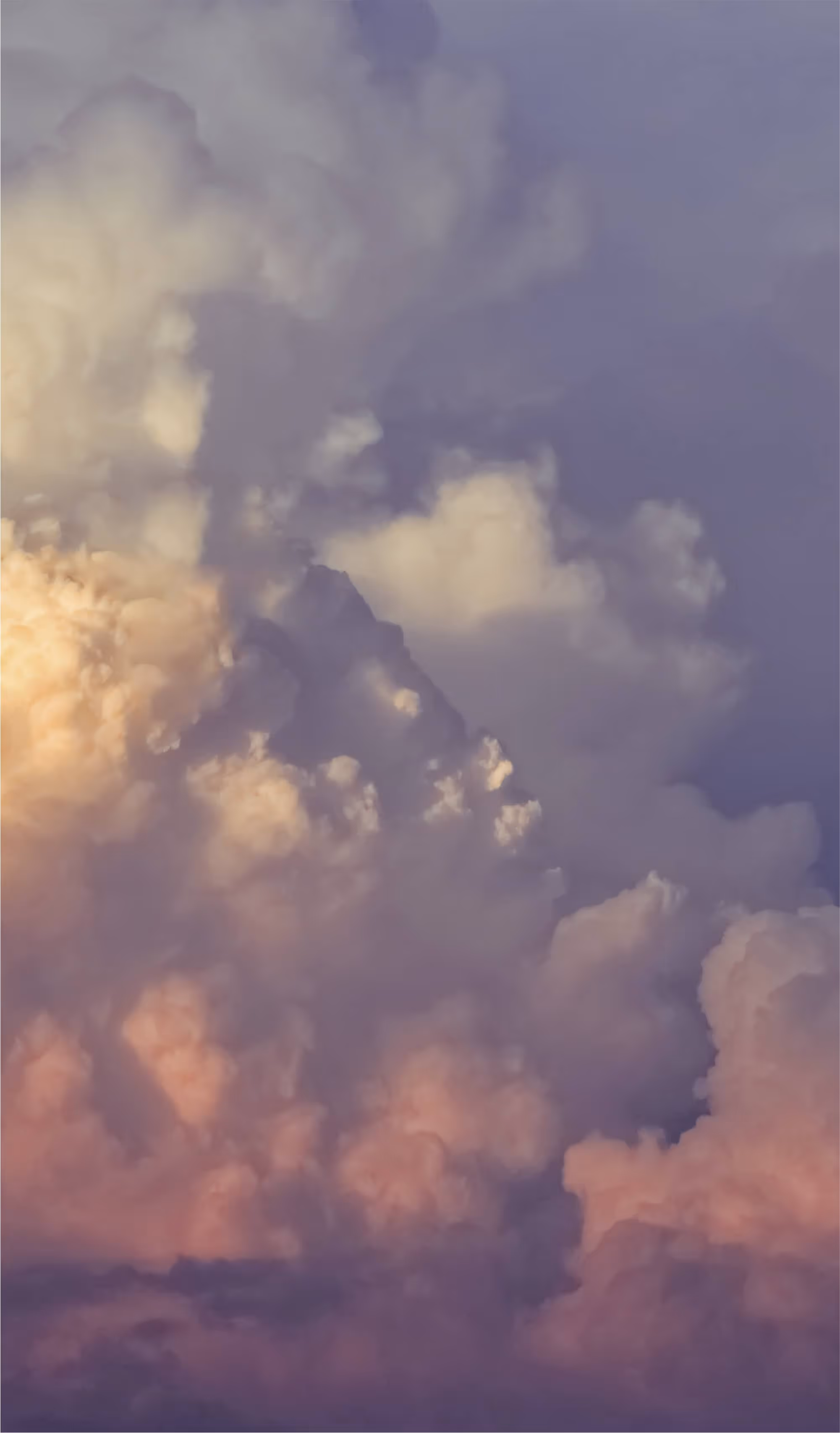 Dramatic clouds in warm and cool tones during a colorful sunset.