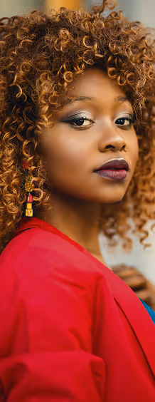 A woman in a red shirt overlooking her shoulder