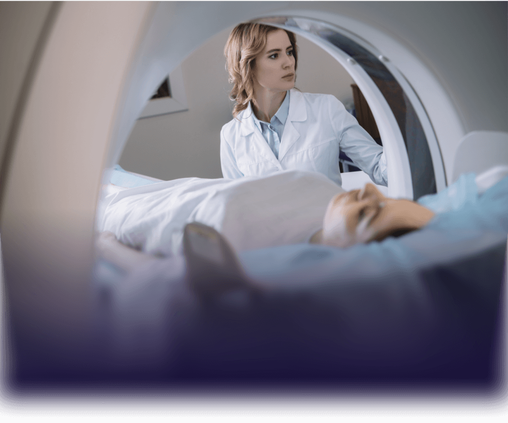 Doctor looking at patient in an MRI machine