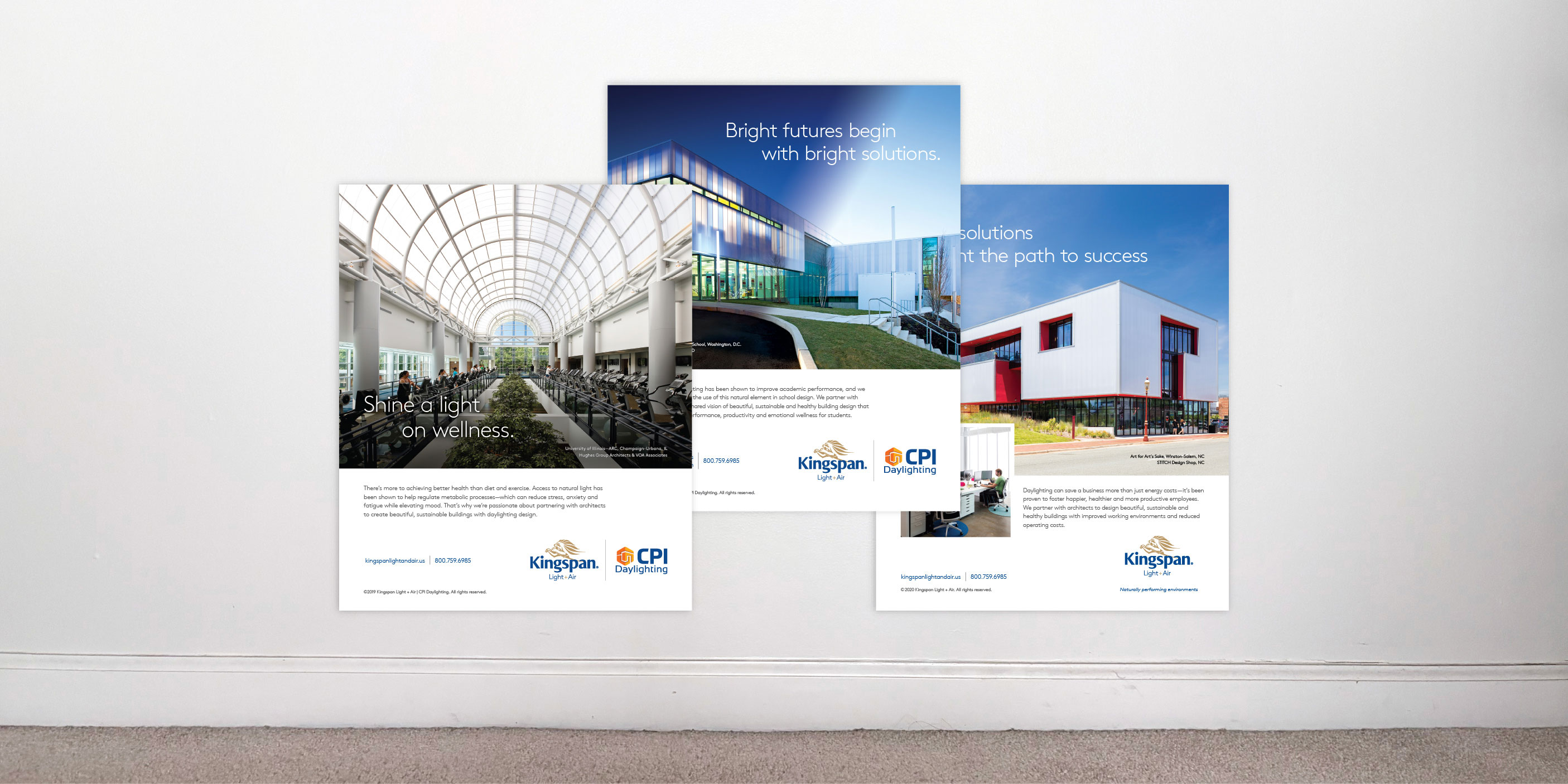 Three Kingspan Light + Air trade ads in front of a blank white wall