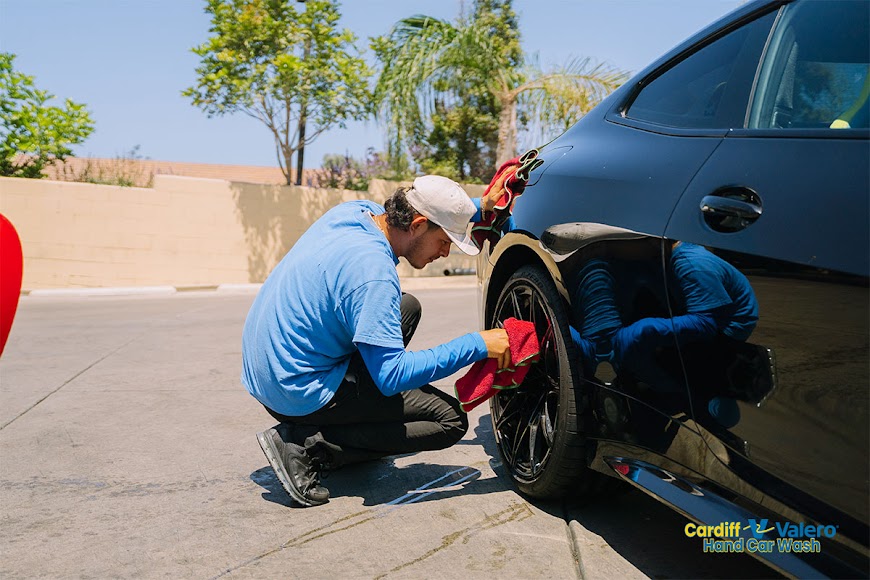 Cardiff Car Wash Employee Cleaning Wheels