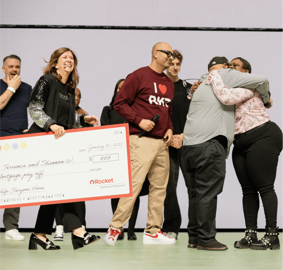 A group on stage celebrates as a large check from Rocket is presented to a couple for their mortgage payoff, dated January 30, 2025.