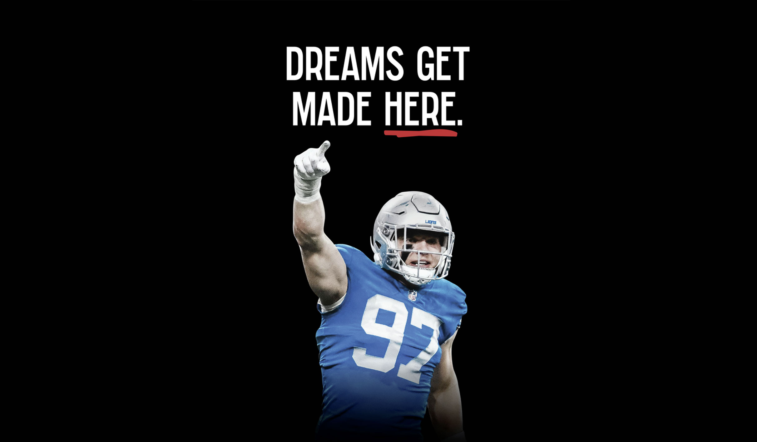 A football player in a blue jersey (#92) points upward, overlaid with the slogan “Dreams Get Made Here.”