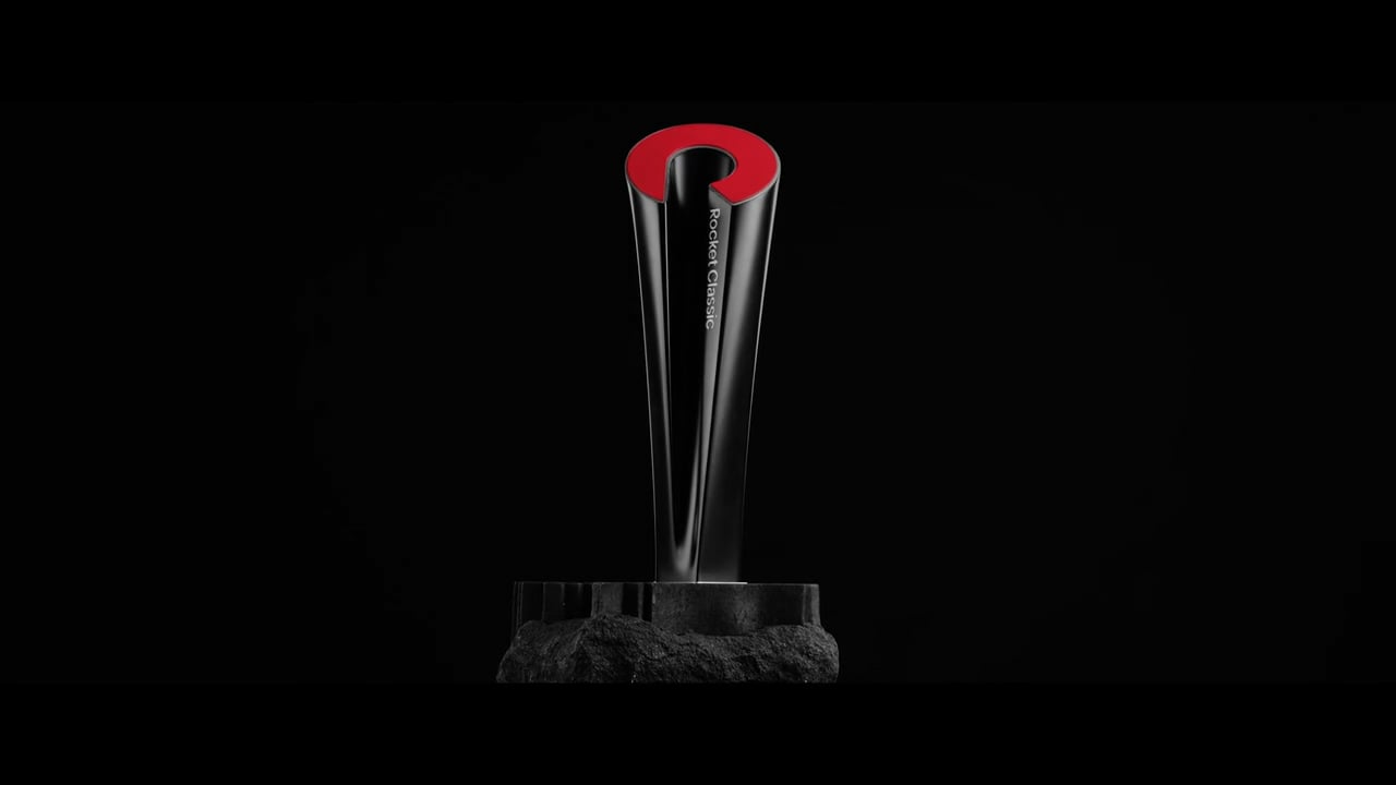The Rocket Classic trophy featuring a sleek black and red modern design standing on a textured black base against a dark background.