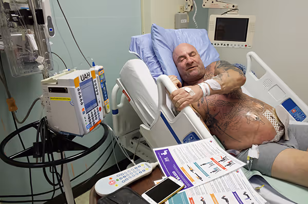 Patient doing BE-FIT exercises in hospital bed.