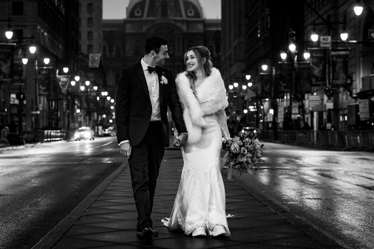Philadelphia wedding couple walking downtown at night, planned by top Philadelphia wedding planner.