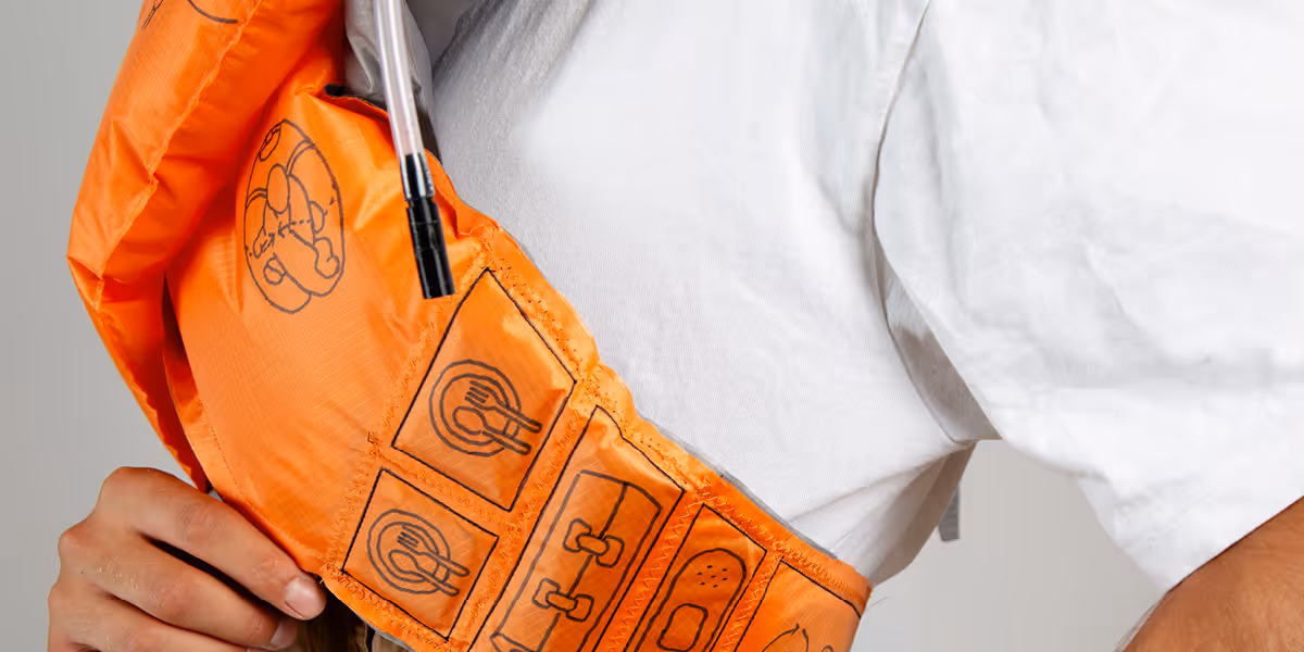 VITAPACK life vest detail showing dual air chambers and roll top closure