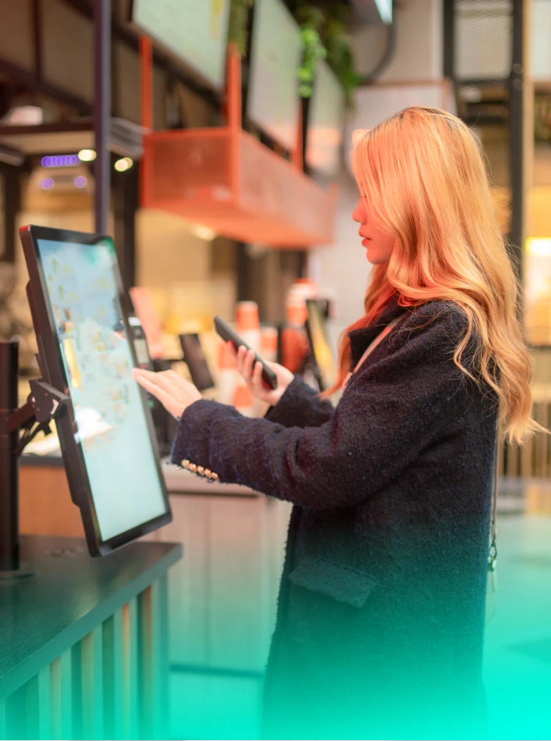 Woman at fast food take away self-service check out buying food.