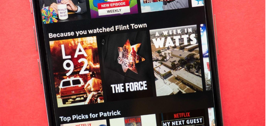 Phone screen shows Netflix recommendations under the '"Because you watched" section