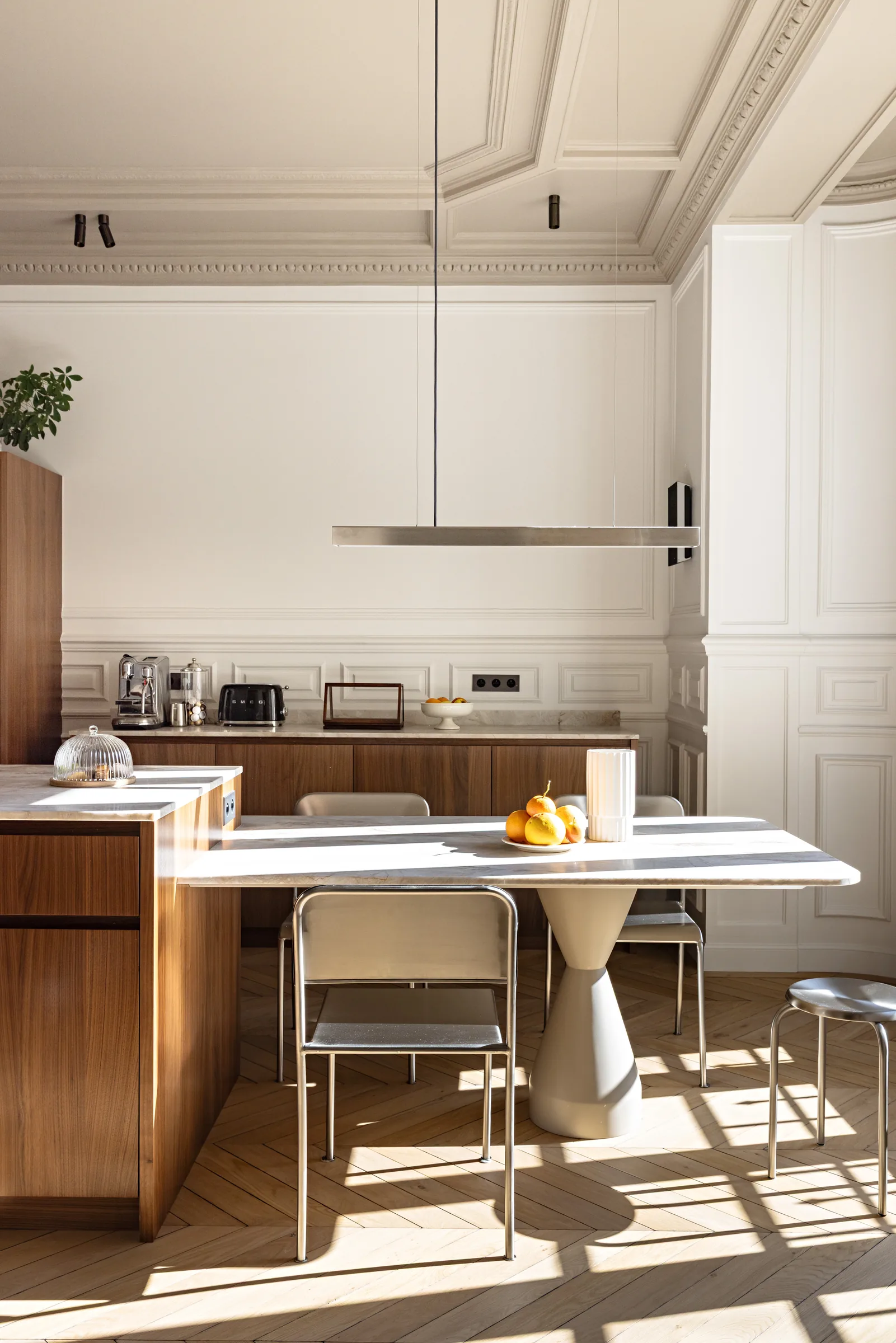 Îlot de cuisine avec assises et suspension linéaire, rénovation d'appartement à Paris par CETEG