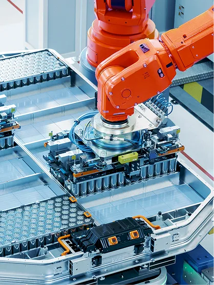 Industrial robot assembling battery cells in a smart factory.