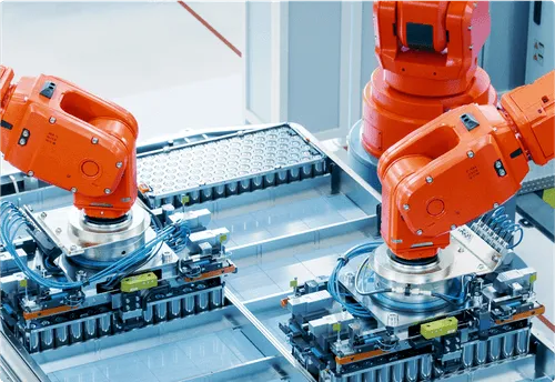 Industrial robot assembling battery cells in a smart factory.