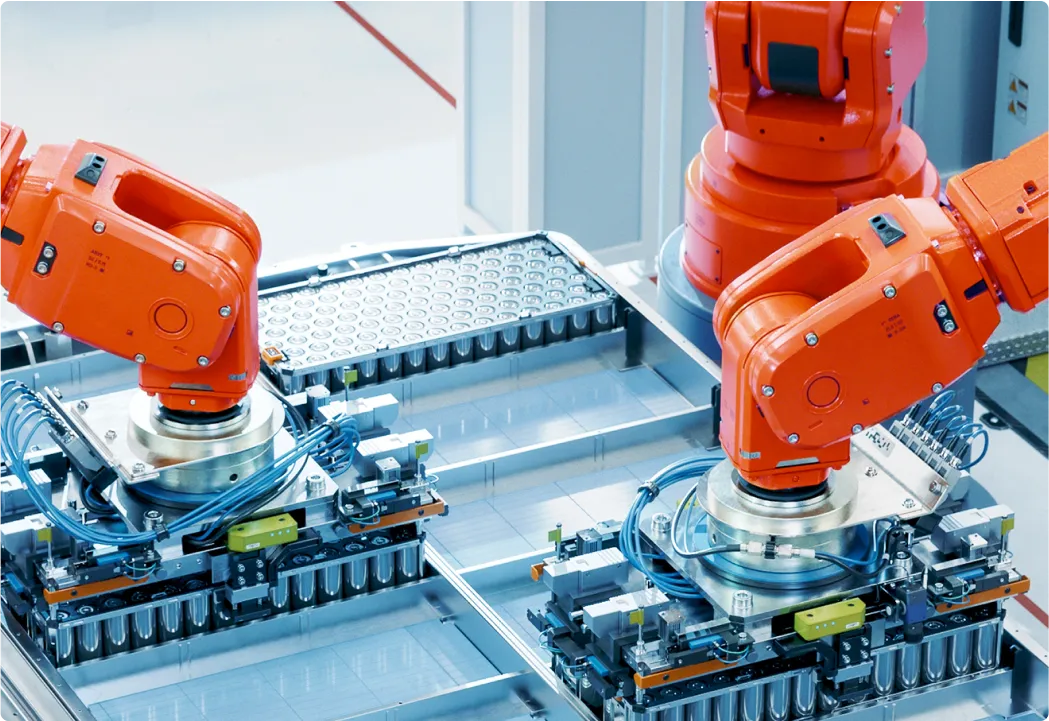 Industrial robot assembling battery cells in a smart factory.