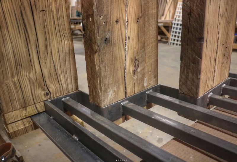Image of reclaimed wood inside a metal frame, stairs being made.