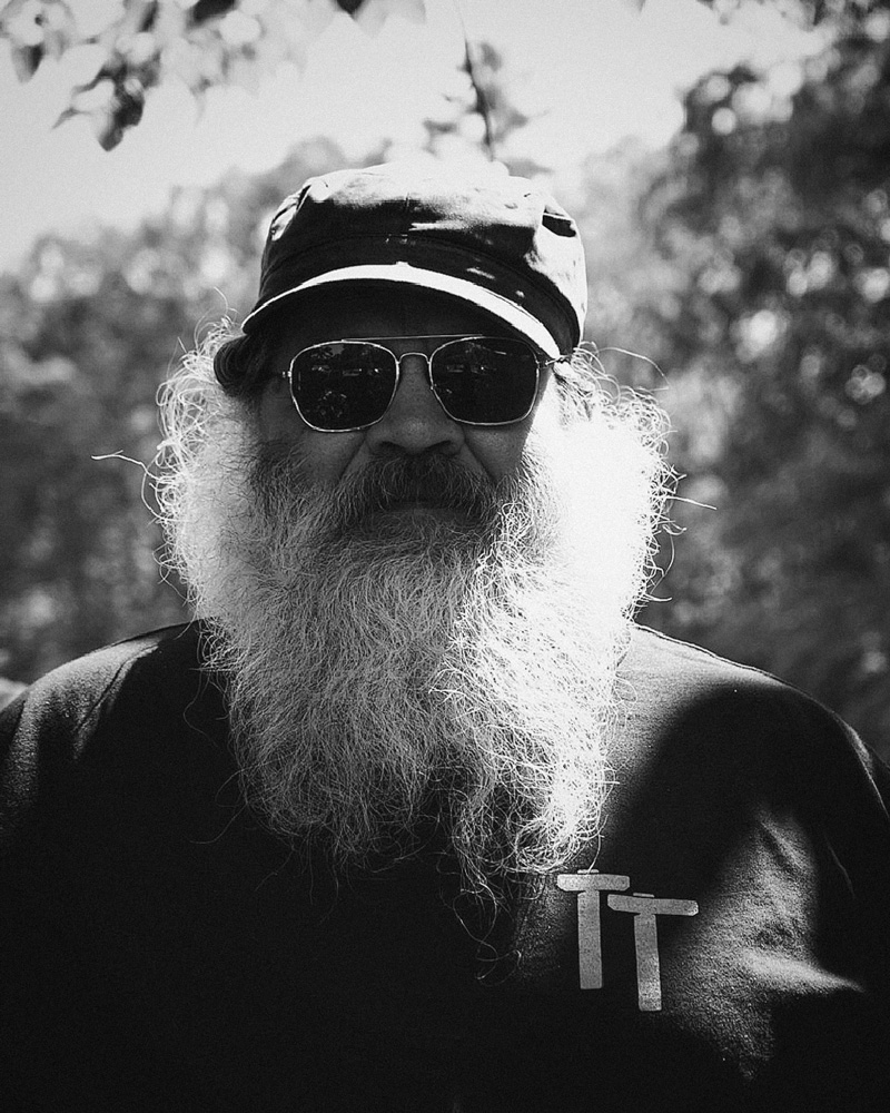 Black and white portrait of Al Litchfield. Trees behind.
