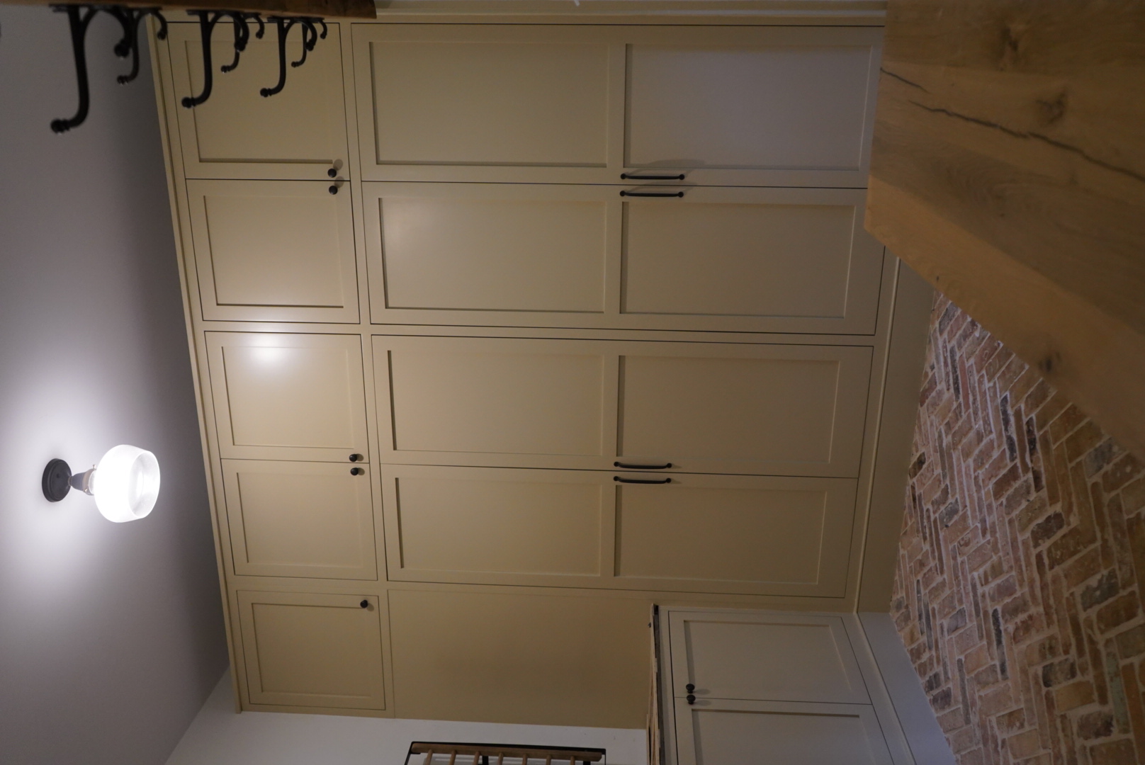 Project detail: Light-color painted floor to ceiling cabinets inside a mudroom.