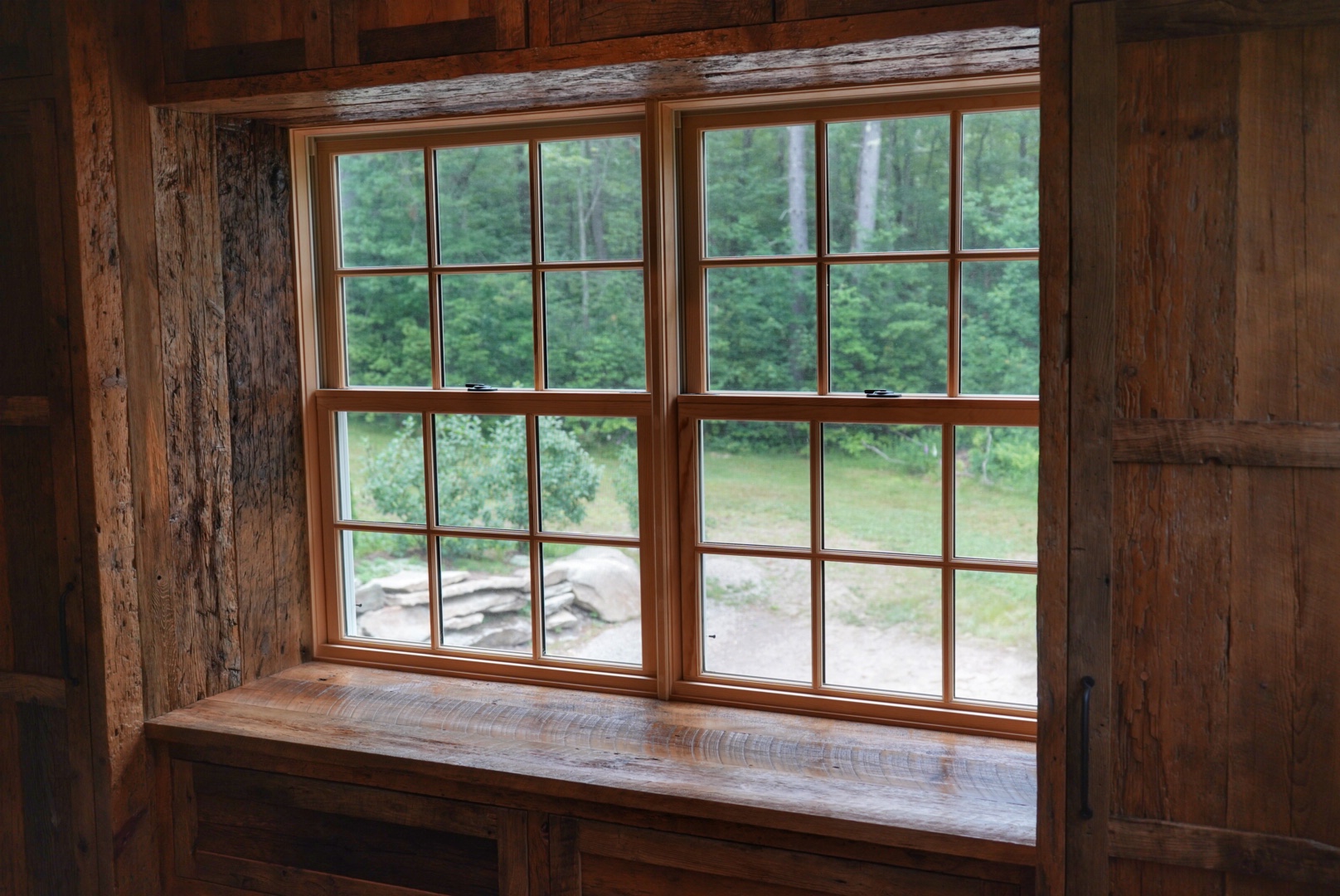 Image of a detailed window sill with reclaimed wood surrond.