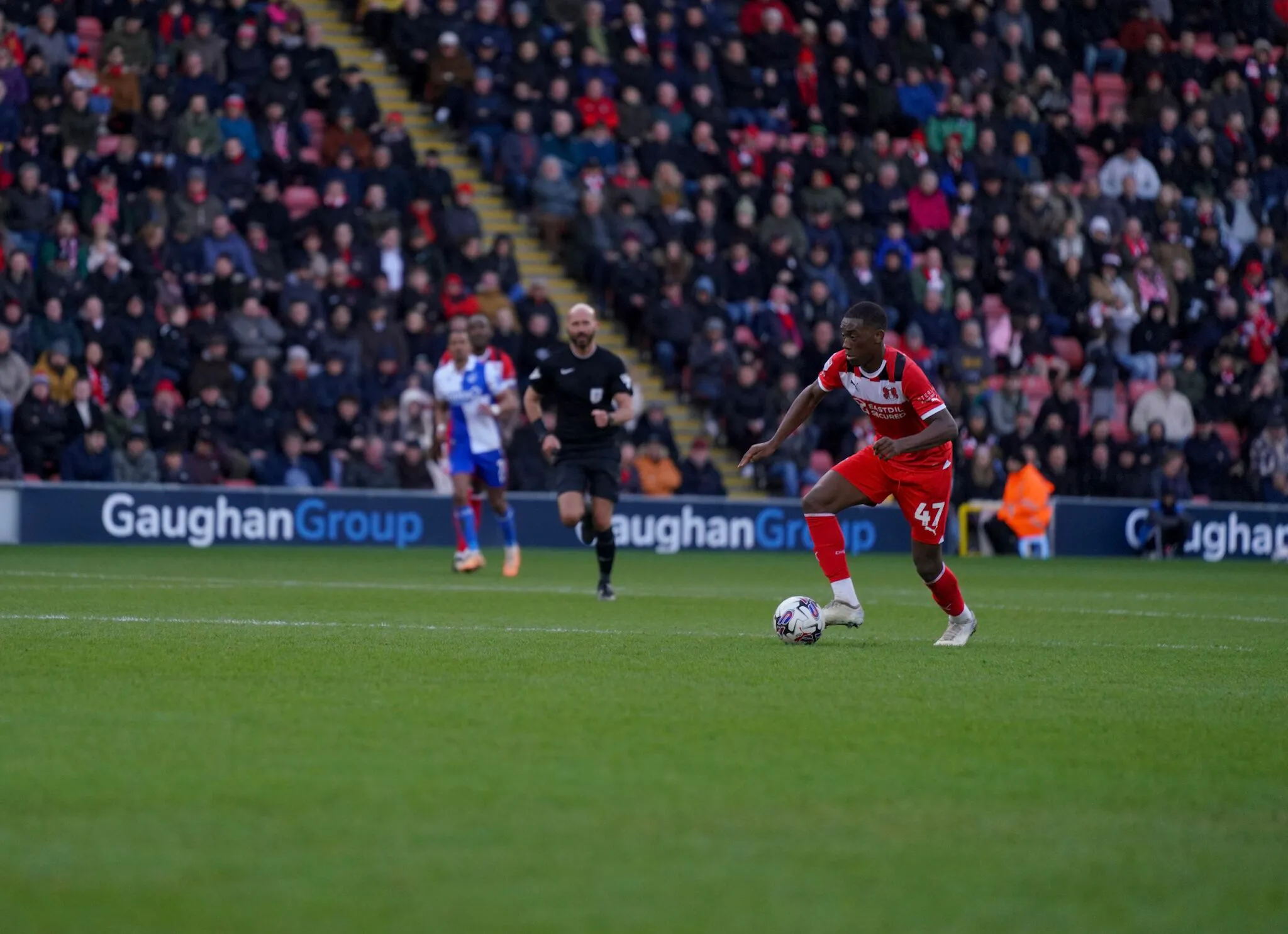 A Man In Red Uniform Playing Soccer On A Stadium