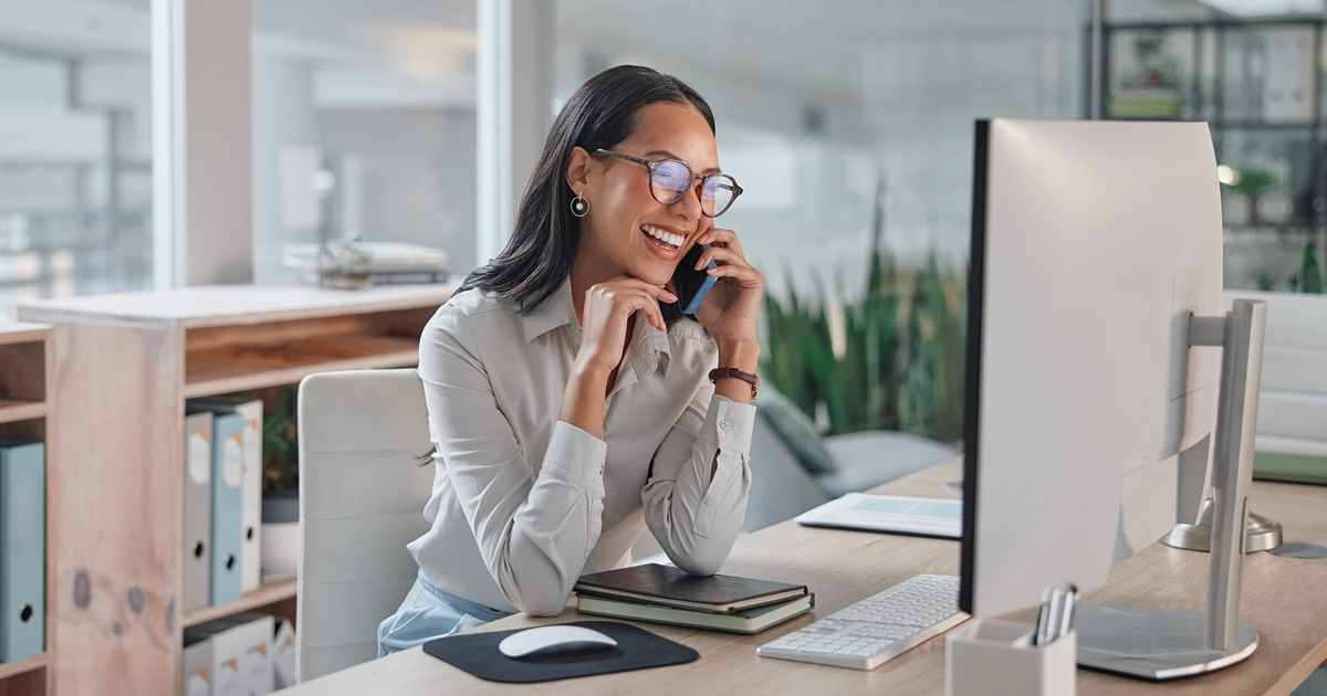 woman on phone at office desk