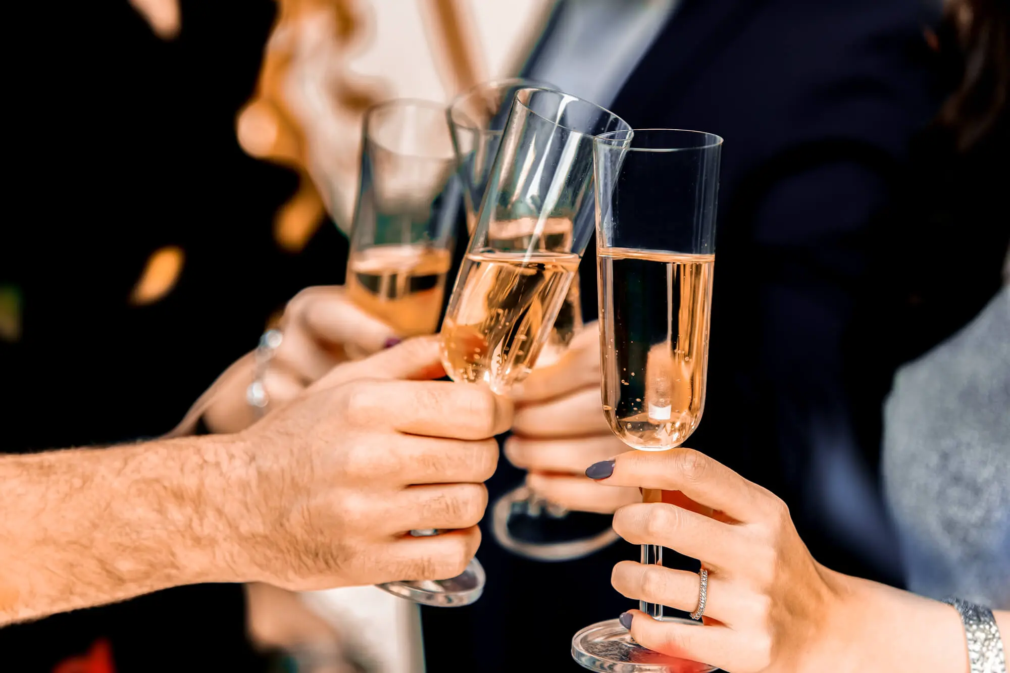 People toasting with champagne during a corporate event on a yacht.