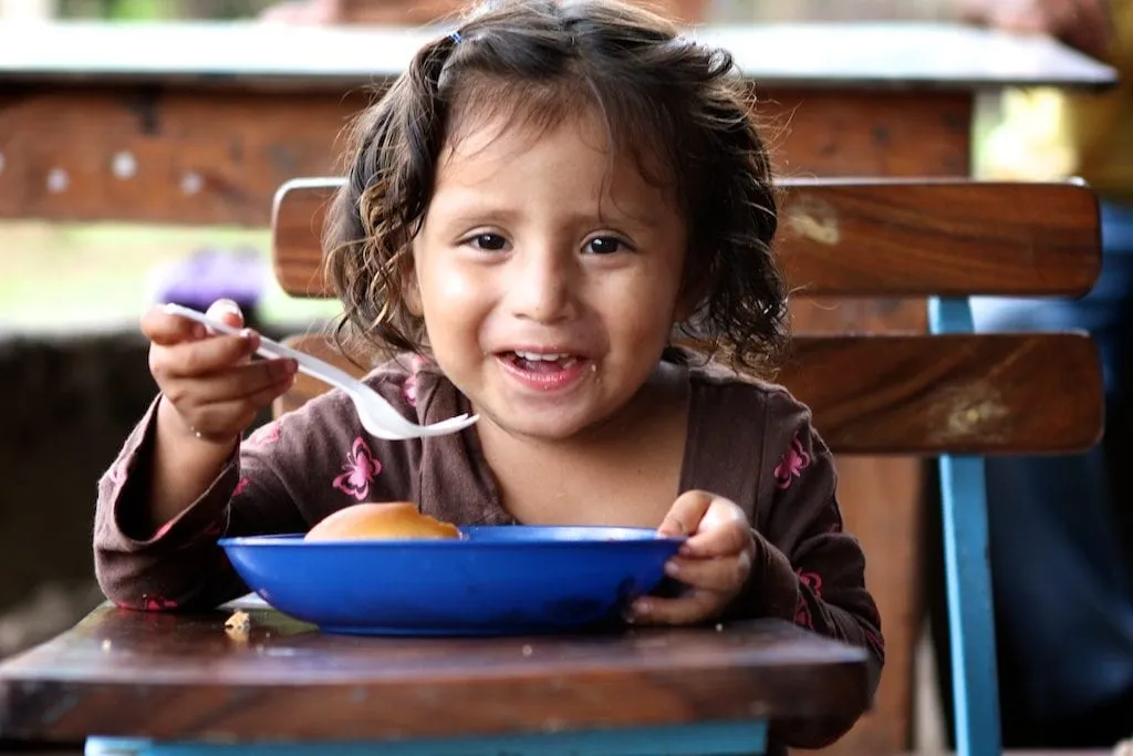 Girl eats meal in Nicaragua