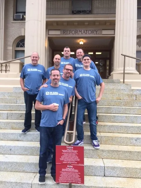 Jared Kooy and team of volunteers stand in front of Prison before the GLS