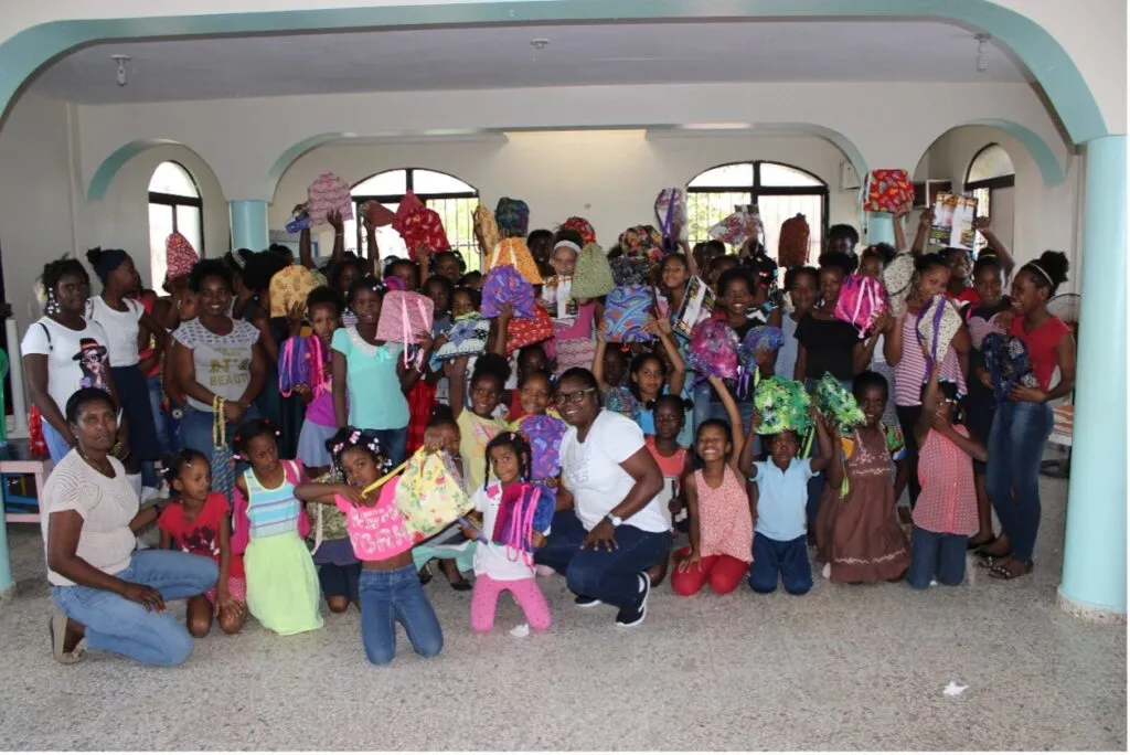Girls hold up their kits in the DR