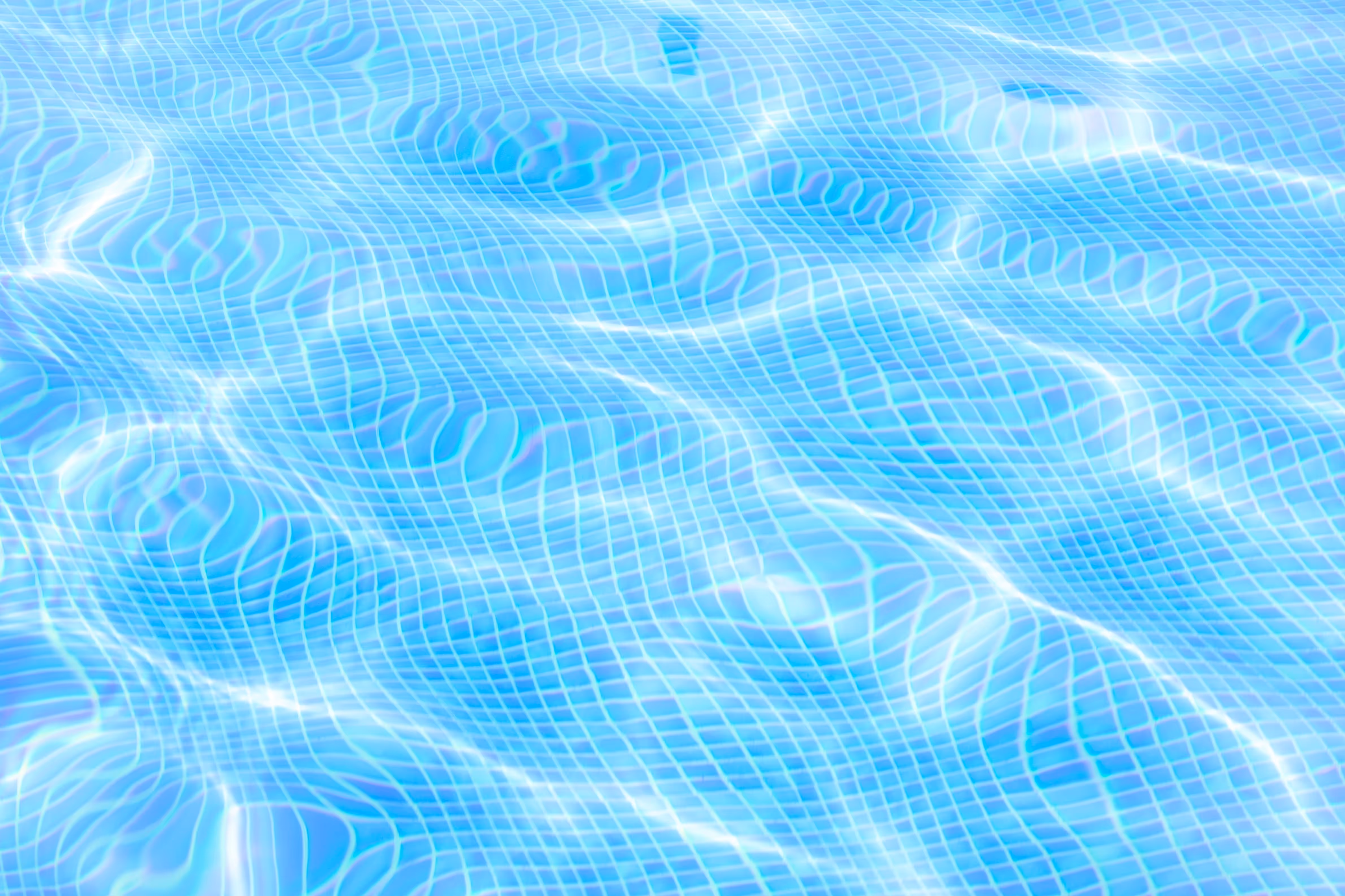 Clear pool water with light reflections.