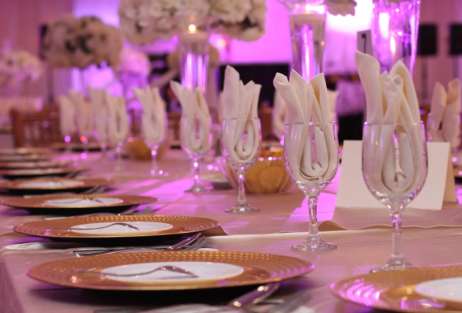 A closeup of a decorated head table setting