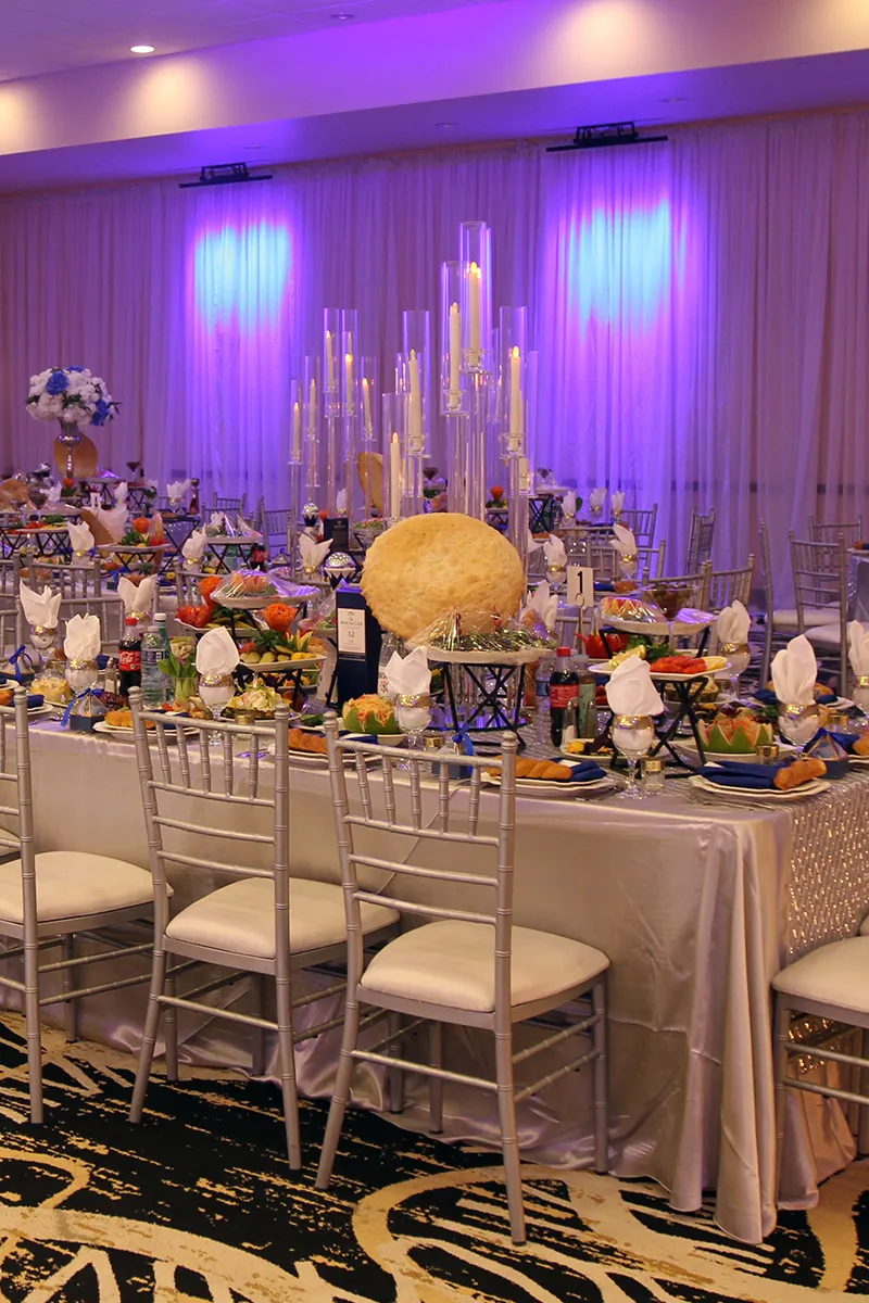 Decorated Family Table with Variety of Kosher Dishes and Drinks