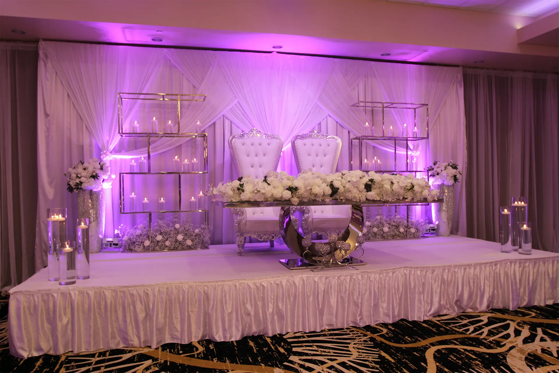 Decorated Head Table on Stage in Venue Ballroom