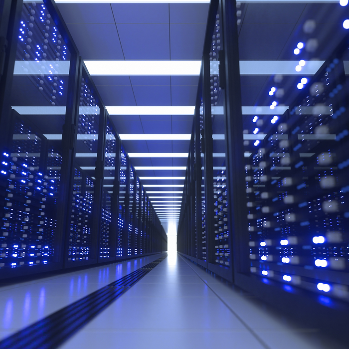 A photo of a hallway lined with technology that has rows of lights on them.