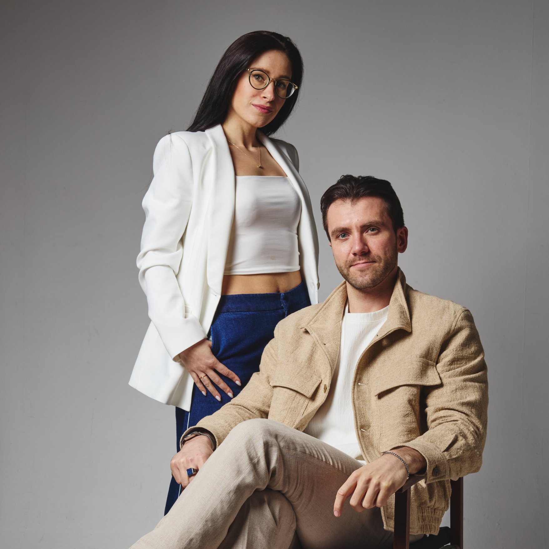 One person standing and another sitting