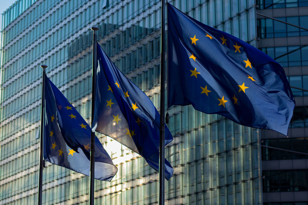 EU flags waving in front of the European Commission building in Brussels, Belgium