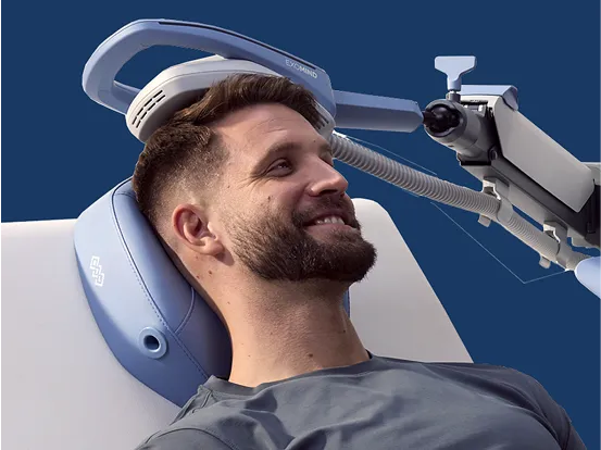 A man laying down with an exomind device on his head.