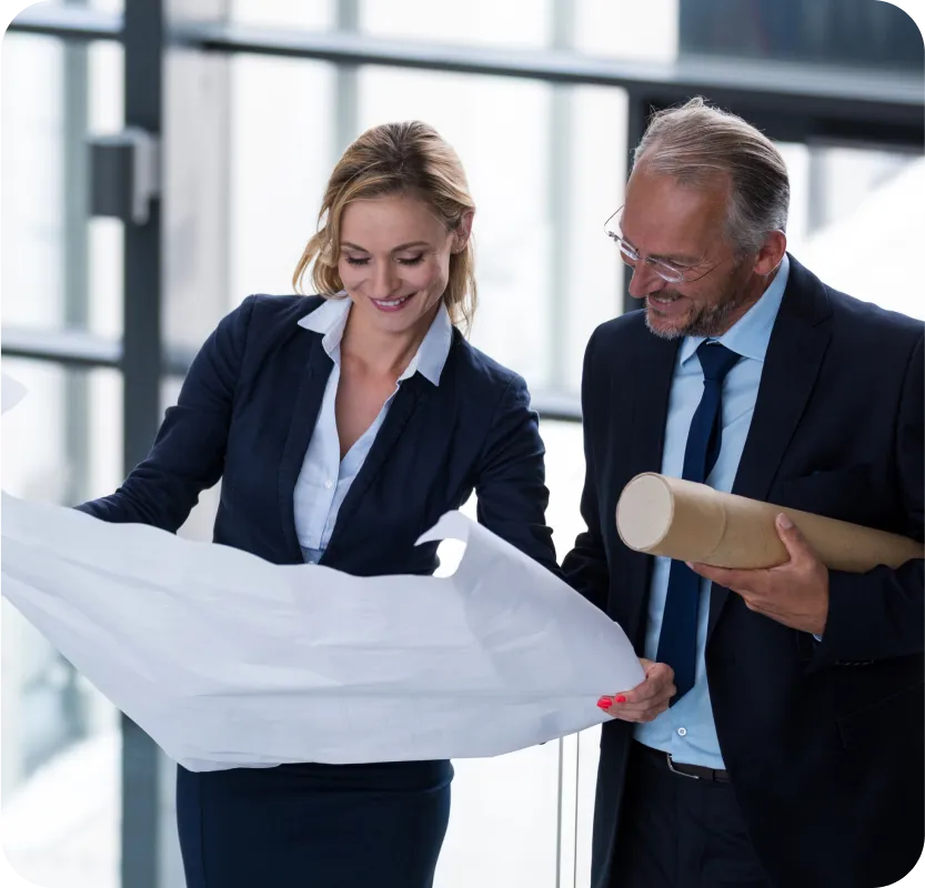 A man and a woman looking at a piece of paper.